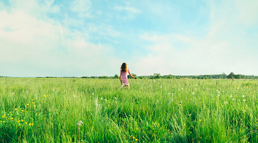 Woman in Tall Grass Field